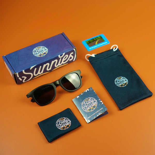 Black flexible polarized kids sunglasses with packaging and accessories, eco-friendly UV protection for ages 3-8.
